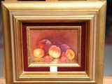 a picture of a painting of peaches in a gold frame