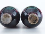 two black and red salt and pepper shakers on a white surface