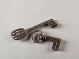 two old keys that are sitting on a table