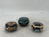 three different types of rings sitting on top of a white surface
