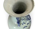 a blue and white vase with a bird design on it