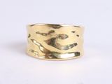 a close up of a gold ring on a white surface