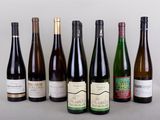 several bottles of wine are lined up in a row on a table