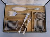 a lot of silver spoons and forks in a box