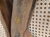 a close up of a chair with a wooden seat and back