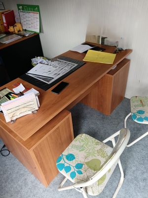 a desk with a chair and a computer on it