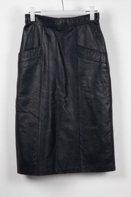 a black leather skirt hanging on a hanger