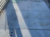 an image of a truck with a flat bed parked on the side of the road