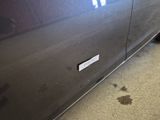 a car with a sticker on the side of it ' s door