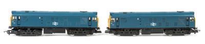 two blue and yellow train cars on a white surface