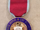 an image of a medal with a red ribbon on a table