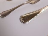 a spoon, fork and spoon rest on a table