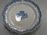 a blue and white plate with a crown on it