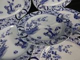 several blue and white plates are stacked on top of each other