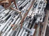 a large pile of metal pipes and poles in a yard