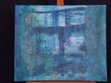 an image of a painting on a wooden easel with a black background