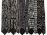 four ties are lined up in a row on a white background