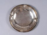 a silver plate on a white table with a white background