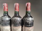 three bottles of wine that are sitting on a table