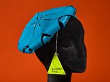 a close up of a mannequin head with a blue hat on it
