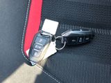a car key sitting on the seat belt of a car