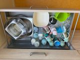 a picture of a kitchen cabinet with a lot of dishes and cups in it