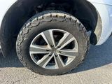 a close up of a tire on a white car