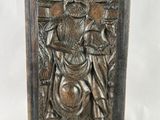 an old bronze plaque with a man holding a shield and a sword