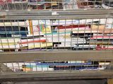 a metal cage with books in it on top of a table
