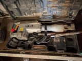 a drill in a tool box with a hammer