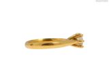 a close up of a gold ring with a single diamond