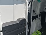 a white van with the door open and a green bag in the back