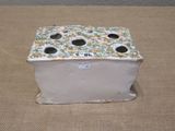 a small box with holes on it sitting on a table