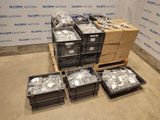 several boxes of assorted items sit on a pallet in front of a wall
