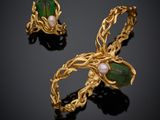 a pair of gold earrings with green leaves and pearls