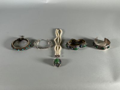 three pieces of jewelry sitting on top of a table next to each other