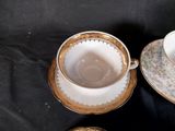 two cups and saucers sitting on a table