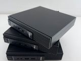 a close up of a stack of four black dvd players