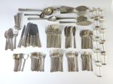 a lot of silver spoons and forks on the table