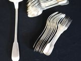 a lot of forks and spoons sitting on a table