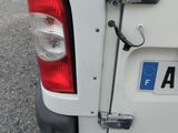 a close up of a white truck with a number plate on it