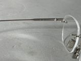 a pair of glasses sitting on a table next to a pair of scissors