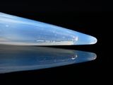 a close up of a plastic object on a black surface