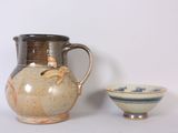 a vase and a bowl sitting next to each other on a table