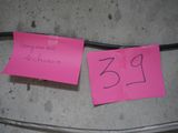two pink post it notes attached to a wire