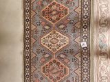 two rugs with fringes on them on a white surface