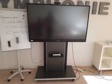 a flat screen tv sitting on a stand in a room