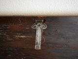 a close up of a wooden box with a key on it
