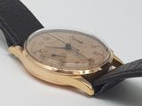 a close up of a watch on a white surface