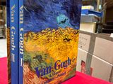 the book van gogh is sitting on a red table cloth